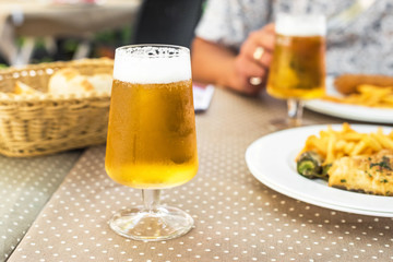 Full glass of freshness beer with foam on table, Siurana, Catalunya, Spain. Close-up.