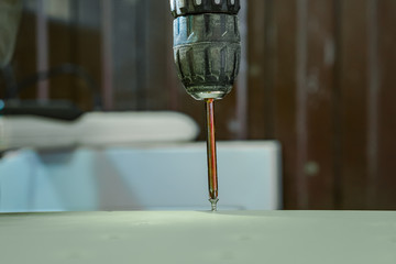 A screwdriver inserted into the screw head.