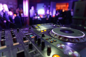 DJ Mixer. Blurred background.  the image has a little noise