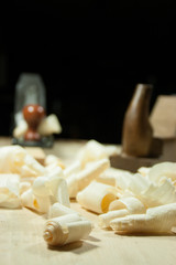 wood shavings in focus and the woodworking planes out of focus.