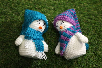 Christmas gift little snowman on green background