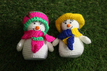 Couple of christmas gift little snowman on green background