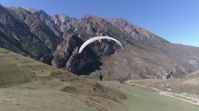 Paraglider take off. Following with the drone