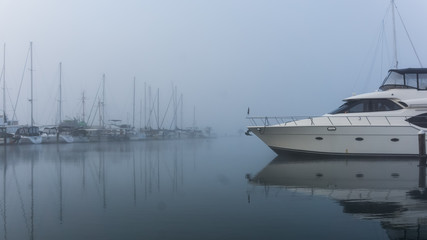 Moored boat on a cold misty morning
