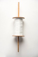 Wooden Spool or chakri/reel/fikri with pink or white thread, isolated over white background