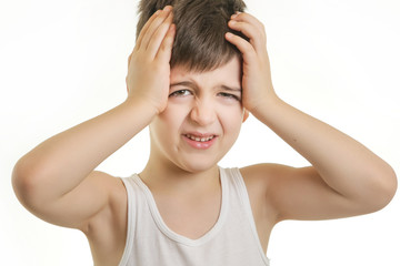 Studio shot of young boy holding head. Headache concept or ops I forgot it.
