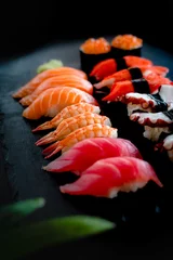 Foto op Plexiglas Set of Sushi & Sasimi on black stone plate © 9mot