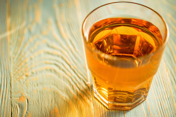 Glass of fresh apple juice or cider on wood table
