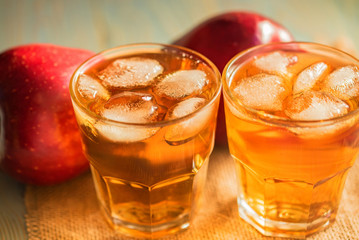 Fresh apple juice or cider in glasses on table