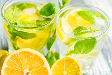 Lemonade or mojito cocktail with lemon and mint