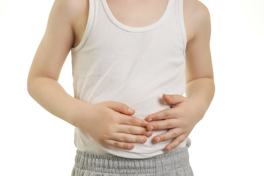 Studio Shot Of Young Boy With Stomach Pain