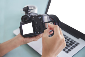 hand of photographer inserting the memory card to the camera