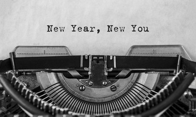 New Year New You message typed on a vintage typewriter, old paper. close-up