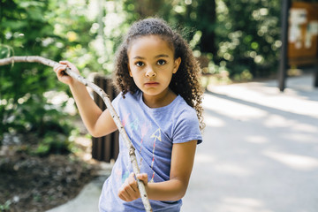 Portrait of girl holding branch