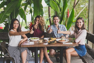 group of four best friend doing high five while having their lun
