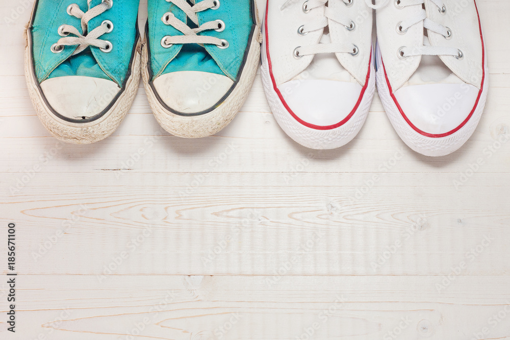 Wall mural top view of the a pair of new and old sneakers next to each other, the concept of transferring exper