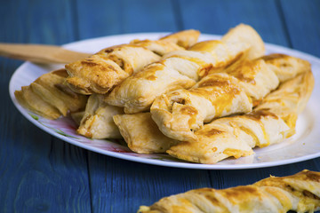Sticks of puff pastry with ham and cheese