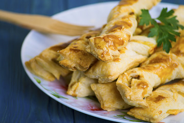 Sticks of puff pastry with ham and cheese