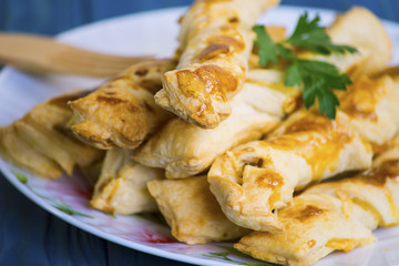 Sticks of puff pastry with ham and cheese