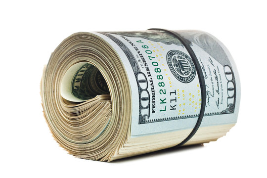 A large roll of hundred dollar bills knitted by a black rubber band isolated on white background.