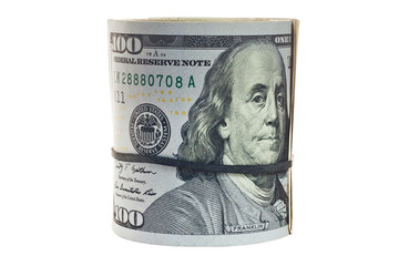 A large roll of hundred dollar bills knitted by a black rubber band isolated on white background.
