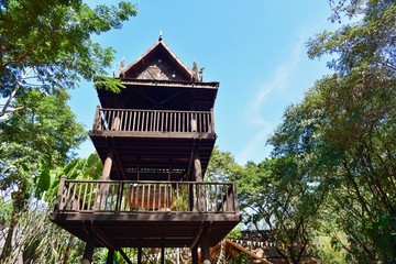 Thai-Style Wooden House in a Lush Green Forest
