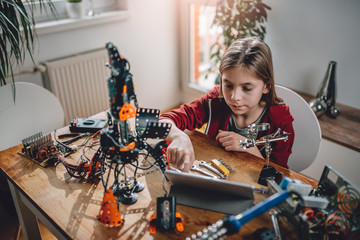 Girl building a robot at home
