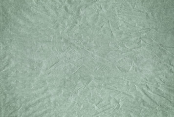 Green blank crumpled and grungy textured paper background