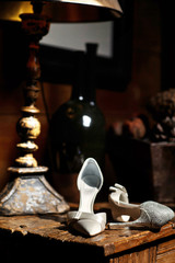 Wedding shoes on a wooden table