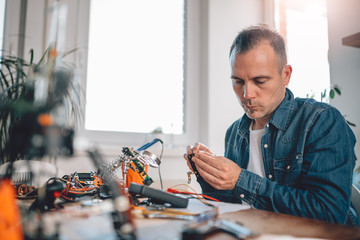 Men working with electronic components