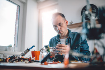 Men working with electronic components