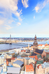 eautiful view of the old town and the steeple of the Dome Cathedral near the Daugava River in Riga, Latvia