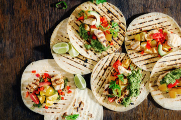 Tortilla with chicken grilled meat, vegetables and avocado sauce