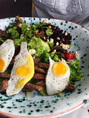 Salad beef meat and quail eggs in plate. Healthy food
