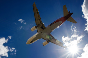 The plane on a background of blue sky and white clouds.