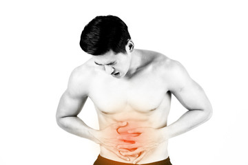 Fitness and health concept. Fit sport man having stomach pain, isolated on white background in studio. Half naked Asian chinese lean muscular male wearing a black shorts.