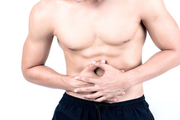 Fitness and health concept. Fit sport man having stomach pain, isolated on white background in studio. Half naked Asian chinese lean muscular male wearing a black shorts.