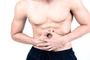 Obraz premium Fitness and health concept. Fit sport man having stomach pain, isolated on white background in studio. Half naked Asian chinese lean muscular male wearing a black shorts.