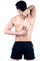 Fitness and health concept. Fit sport man having back injury, isolated on white background in studio. Half naked Asian chinese lean muscular male wearing a black shorts.