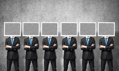 Businessmen with monitors instead of head.