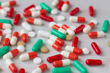 Many tablets are scattered on the table.