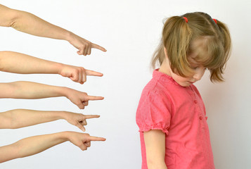 many hands are pointing fingers at the child ,kid of the outcast conceptual photography