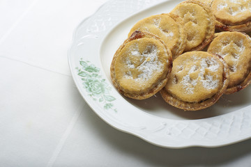 Homemade Christmas Mince pies on a white classic plate.