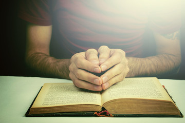 Man is reading a big book