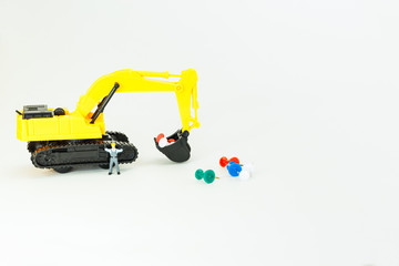 Selective focus of Miniature Worker People, Working with Backhoe and push pin  , on white background