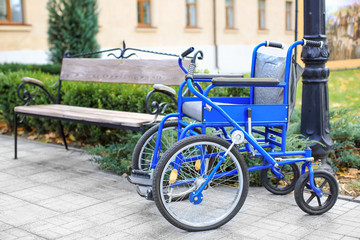 Fototapeta na wymiar Blue wheelchair outdoors on sunny day
