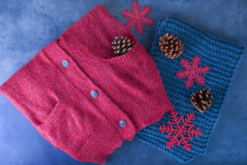 Warm knitted clothes on table. Seasonal female wardrobe
