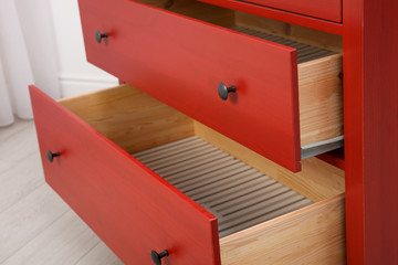 Beautiful wardrobe with open drawers indoors