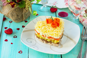 Salad with meat, mushrooms, cheese and vegetables on the festive table on Valentine's Day.
