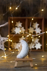 Vanilla crescents and cinnamon stars in the background with a garland, a wooden box and a star.